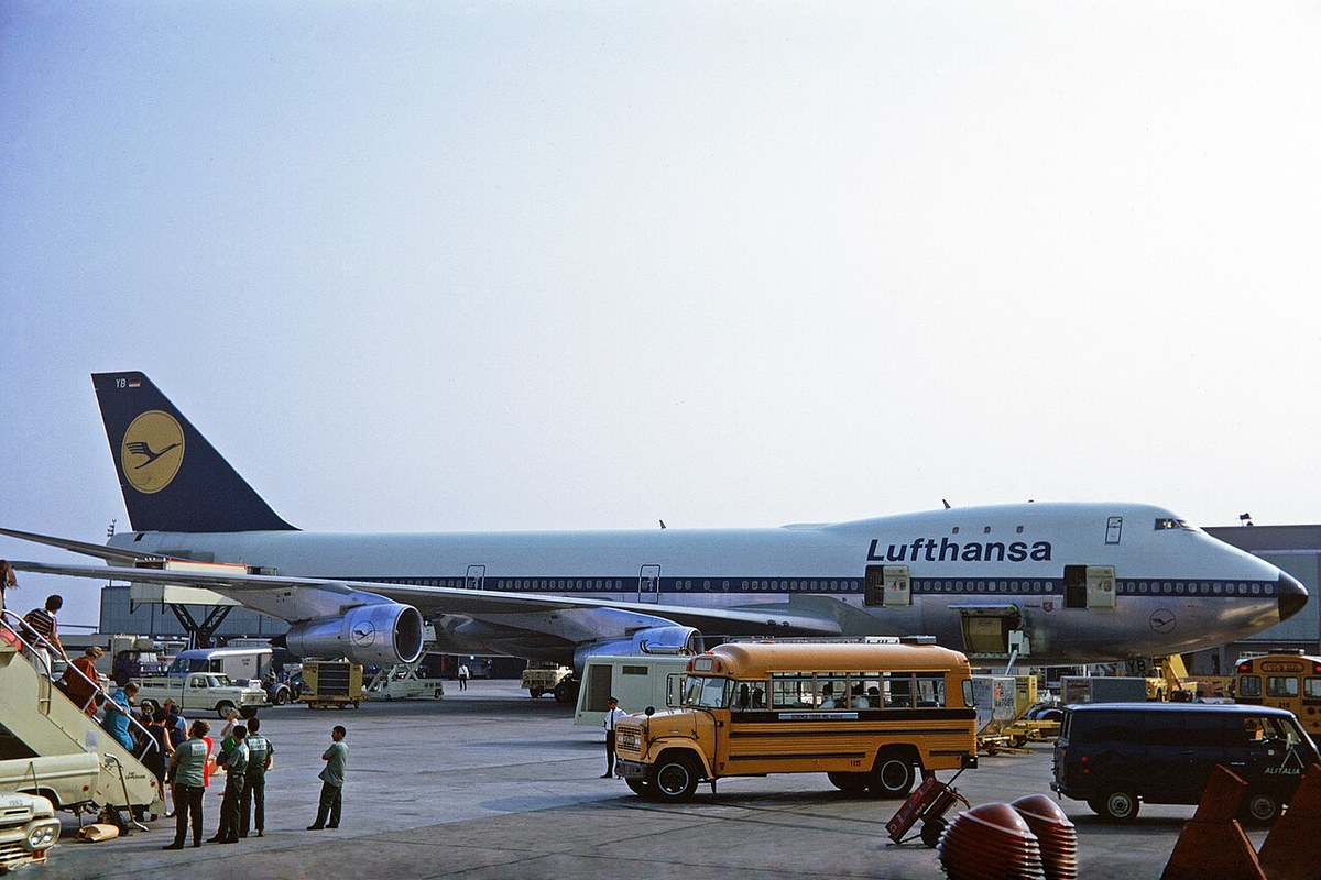 Side view of a Lufthansa four-engine jumbo with a short upper deck ending well ahead of the wing.
