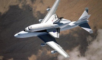 NASA Shuttle Carrier Aircraft seen from above in flight with a Space Shuttle orbiter on its back